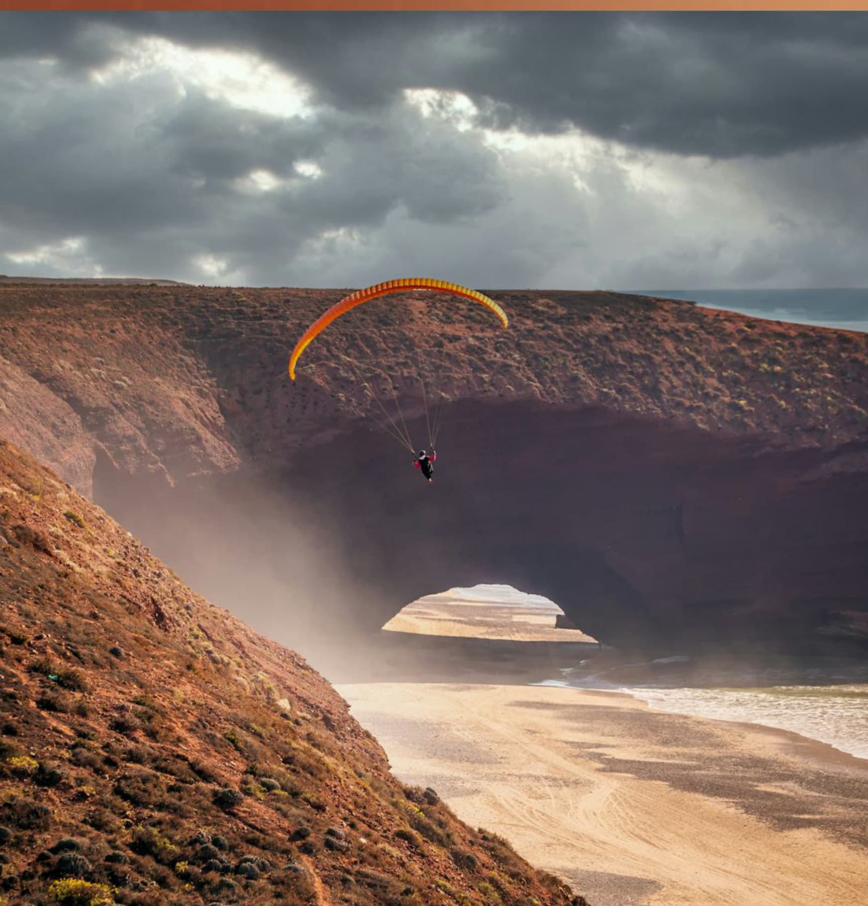 Paragliding over the Legzira Arch on Morocco's Atlantic coast